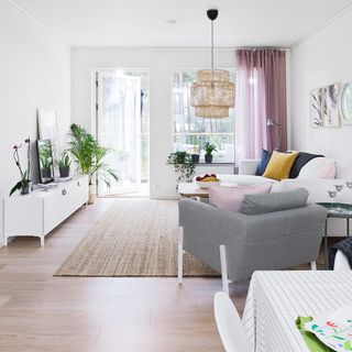 living room with white wall sofa set glass door glass window and wooden floor
