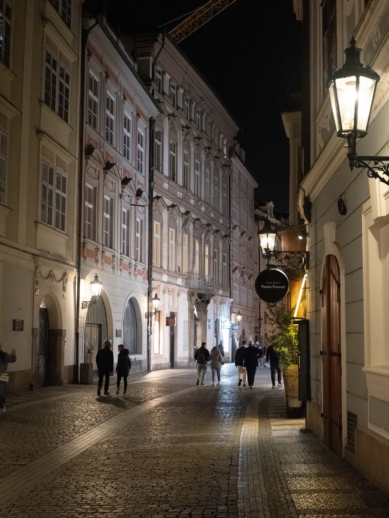 A street in Prague lit up at night