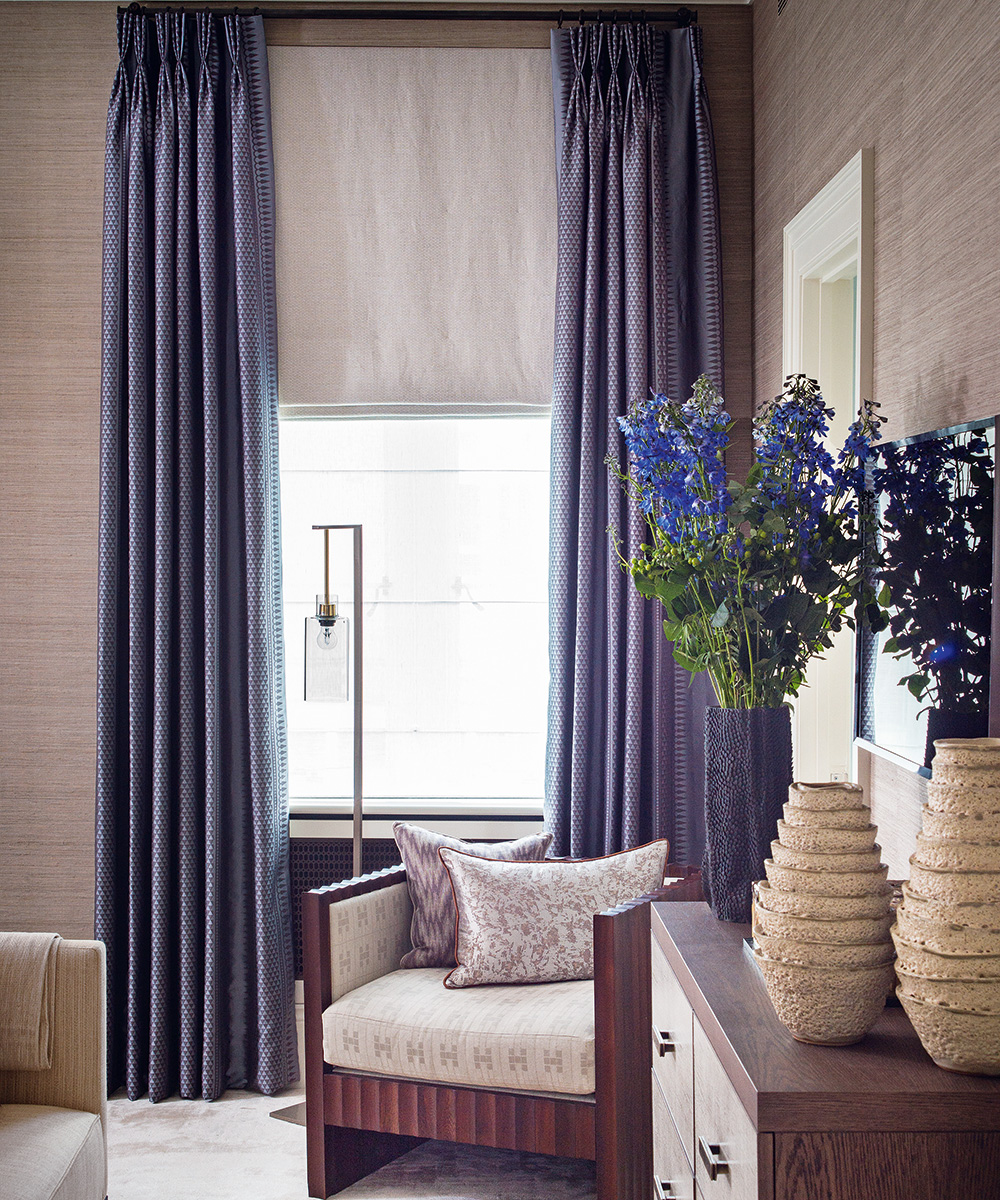 A window with floor to ceiling curtains