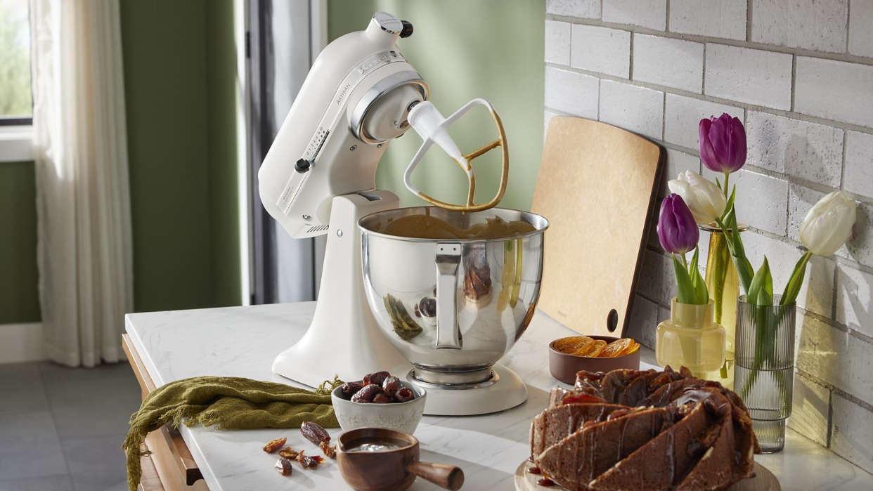White KitchenAid stand mixer with beating attachment