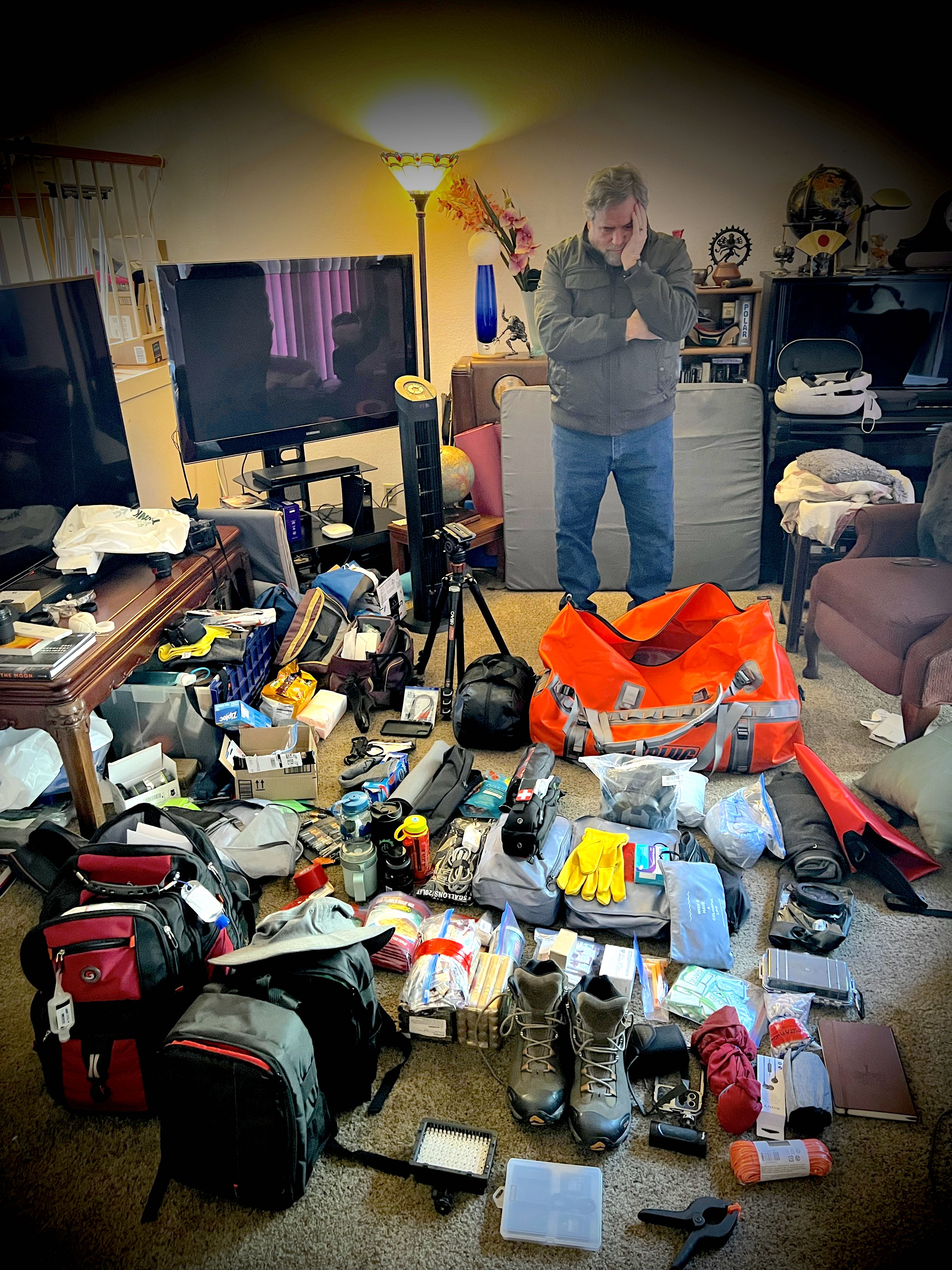 Rod Pyle looks at all his equipment scattered on the ground around him as he prepares to simulate a Mars mission in the North Pole.