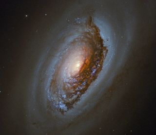 The Hubble Space Telescope snapped this image of the spiral galaxy NGC 4826, which can be found 17 million light-years away from Earth. The galaxy, which lies in the constellation of Coma Berenices (Berenice's Hair), is often called the "black eye" galaxy because of the dark band of dust and gas sweeping across it, which you can see in this image.