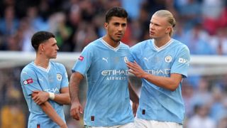 Rodri of Manchester City is consoled by teammate Erling Haaland ahead of the UEFA Super Cup Man City vs Sevilla live stream. 