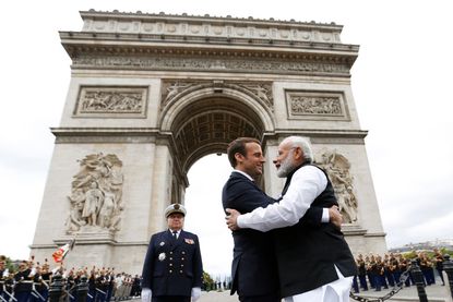  Indian Prime Minister Narendra Modi hugs French President Emmanuel Macron