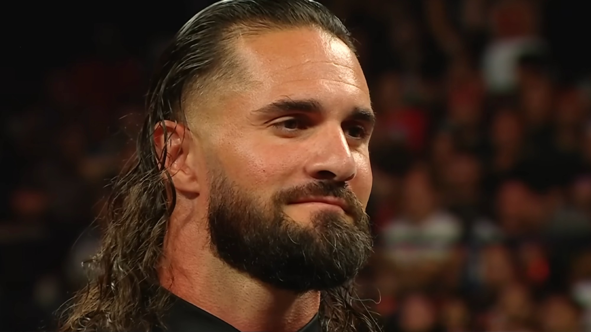 Seth Rollins smiling at LA Knight