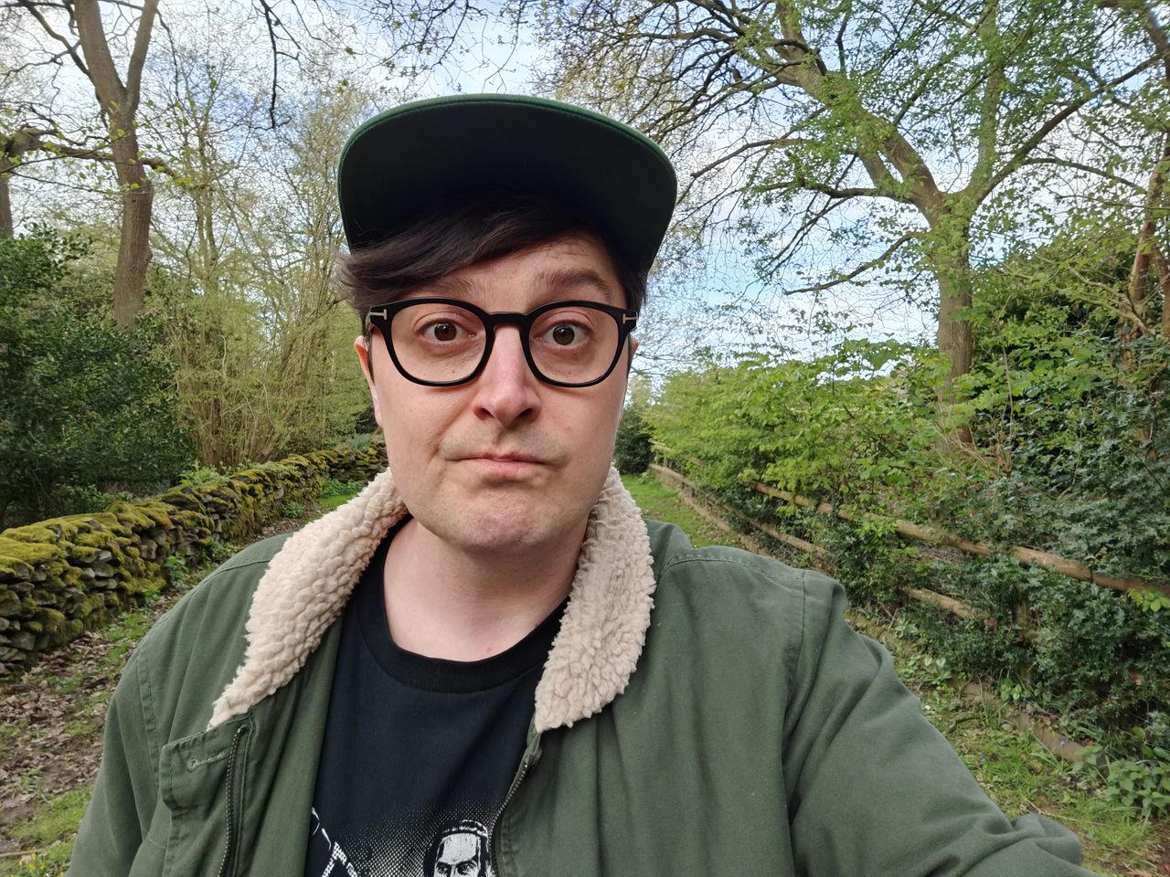 Selfie of a man outside surrounded by trees