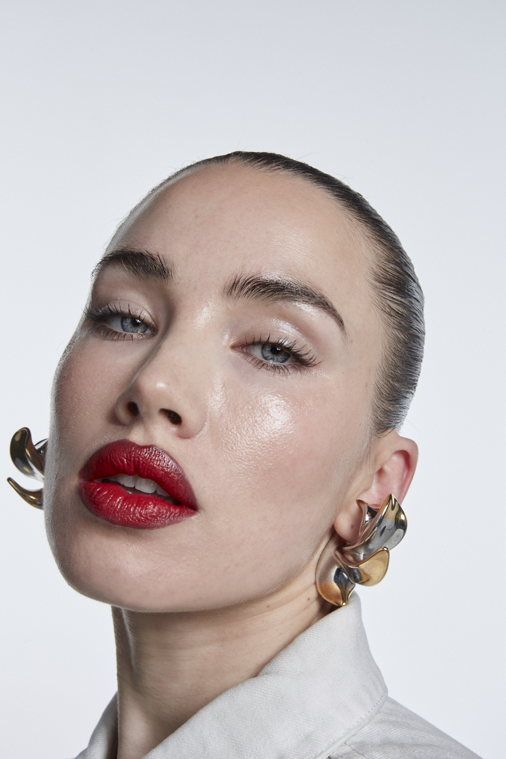 Isamaya Ffrench with glowy skin and a bold red lip