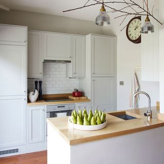 white kitchen with cabinets and worktop