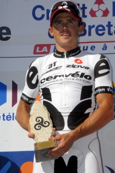 Simon Gerrans shows off his winner's trophy on the podium.