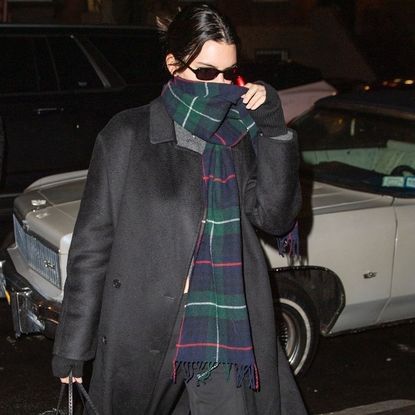 Kendall Jenner in Soho carrying a black tote bag with a gucci wallet