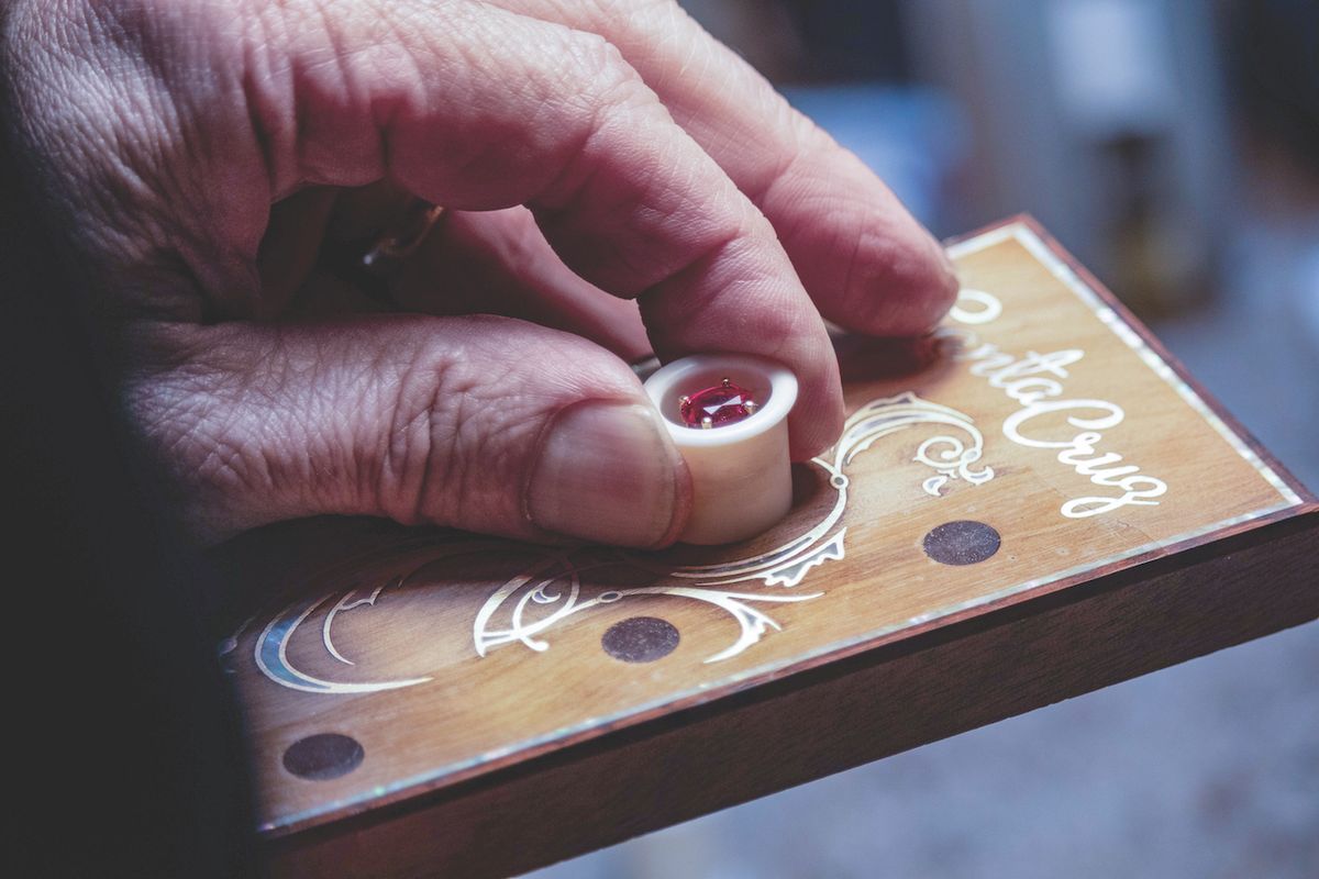 Luthier Adam Rose sets the H13 1854 peghead with a ruby gemstone to float in an oval ivoroid window and ancient kauri overlay.