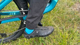 Close up of lower half of rider's leg wearing Mons Royale Virage Pants