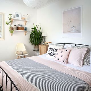 bedroom with white wall and open shelves