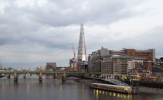 London cityscape with The Shard and a boat on the Thames