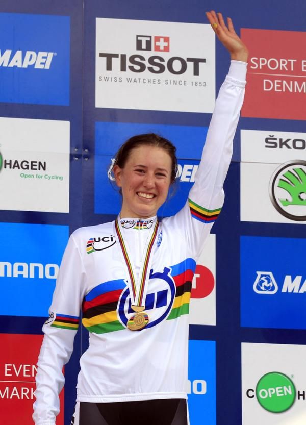 Allen waves to the crowd wearing her rainbow jersey