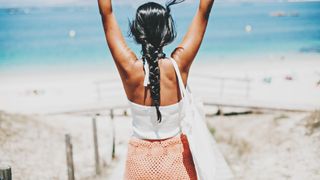 woman walking down to beach