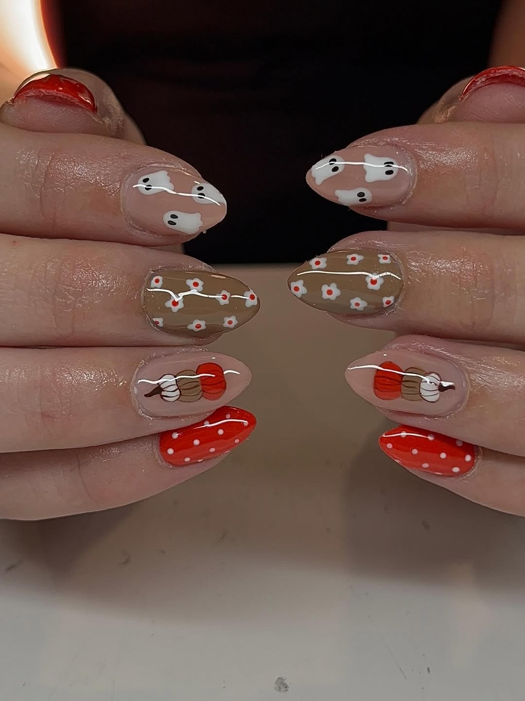 halloween nail art with a brown nail base and red and white accents