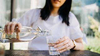 Woman pouring a glass of water