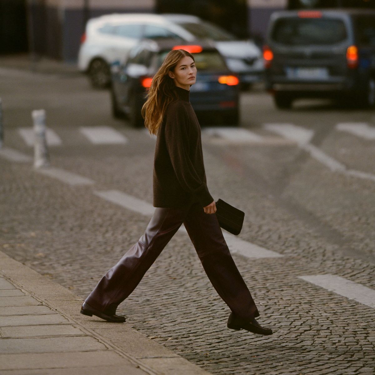 a model wearing a cashmere jumper and leather trousers from reformation