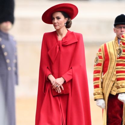 Kate Middleton in a red bow cape coat.