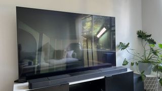 LG QNED81 TV with a reflective surface