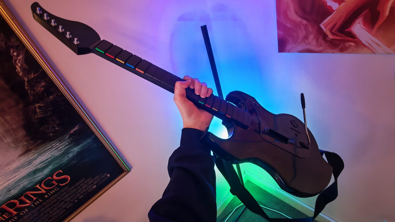 A reviewer holding the PDP Riffmaster guitar controller