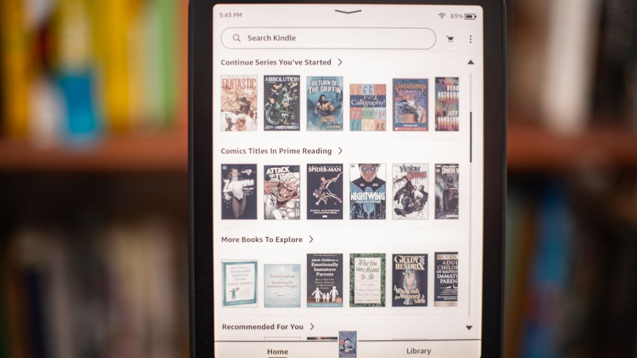 Amazon Kindle Colorsoft Signature edition e-reader showing graphic novels, cookbooks, and fiction, as well as settings
