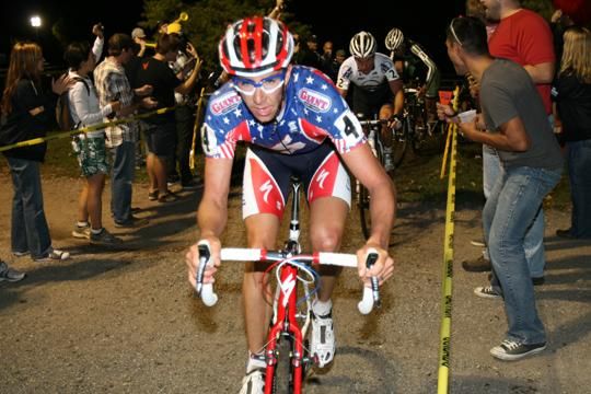 US champion Todd Wells races through the tunnel of fans.