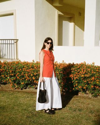 @francescasaffari wearing a red vest and white skirt