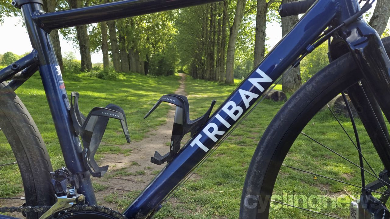 A close up of the Triban's front triangle with two carbon bottle cages installed