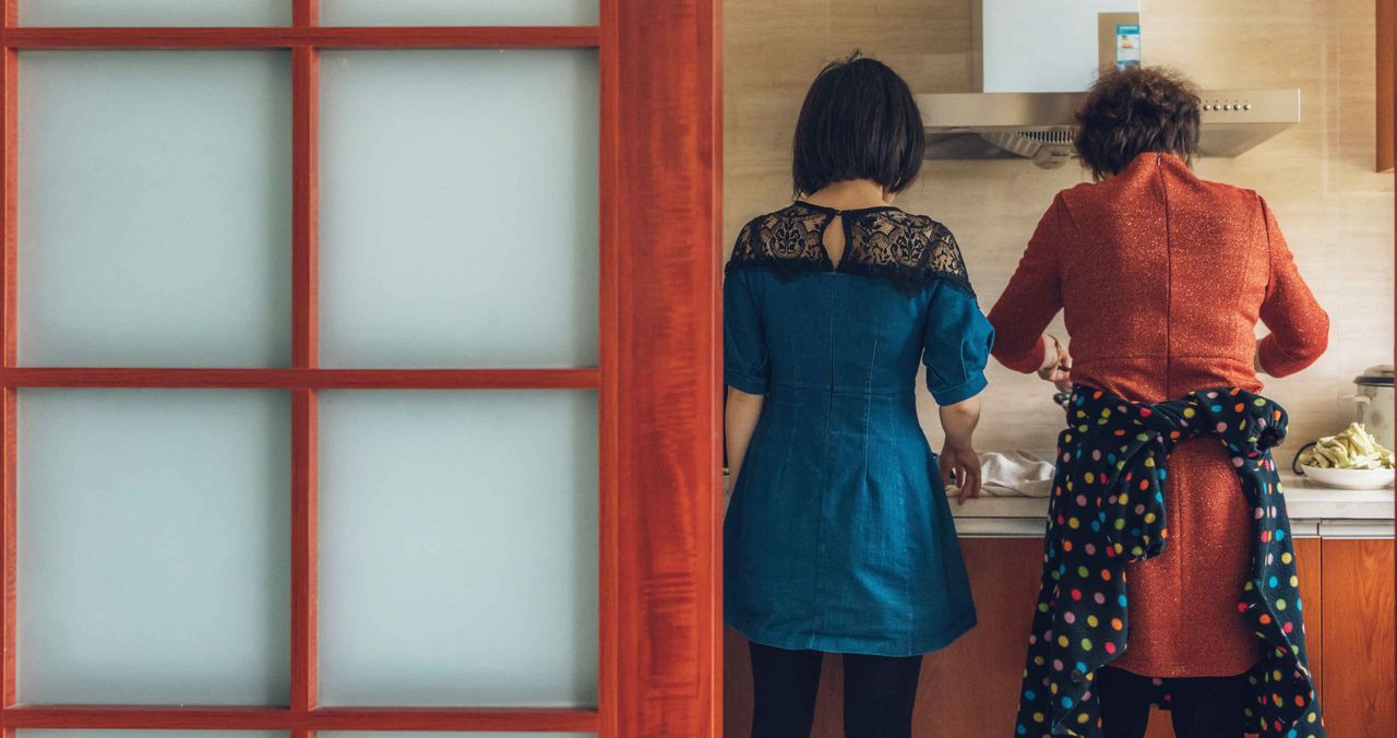 Mother and daughter working in kitchen together