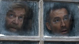 Troy and Nikolai look out the window of his place. 