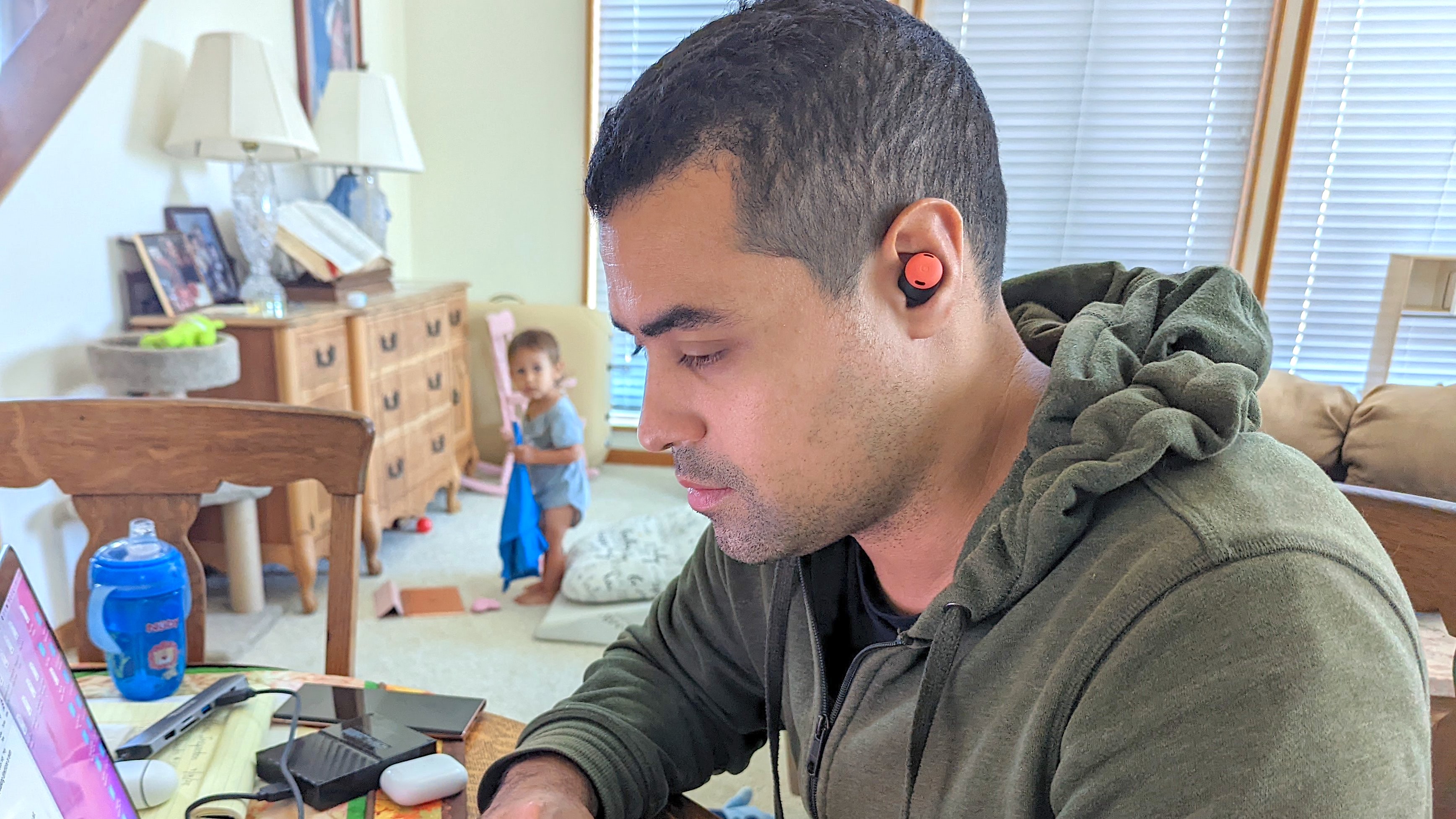 Our reviewer testing the Google Pixel Buds Pro's active noise cancellation in his child's playroom