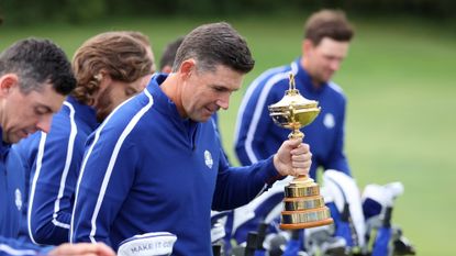 Captain Padraig Harrington of Ireland and team Europe holds the Ryder Cup