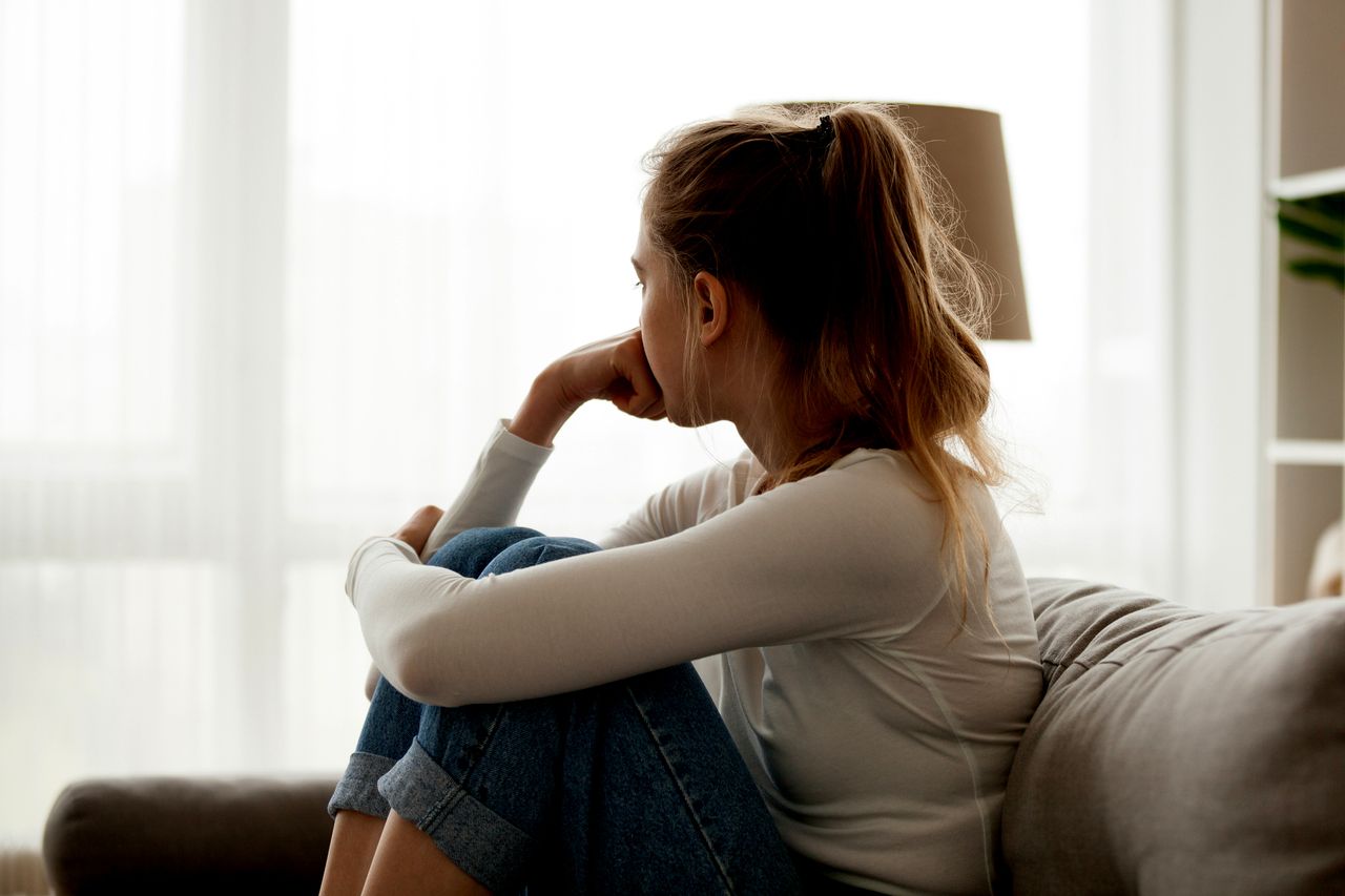 A woman looking out a window.