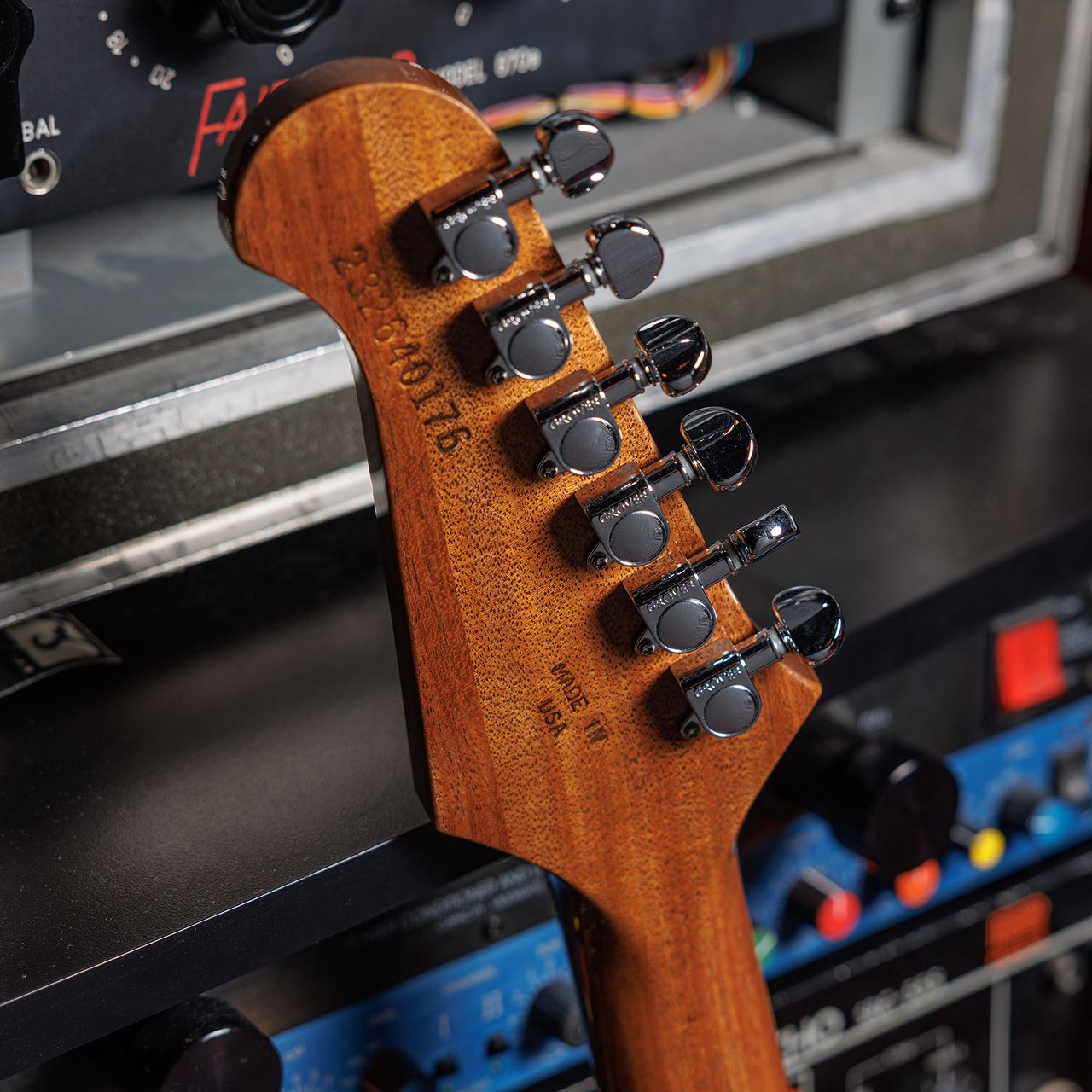 A photo showing a detail of the Gibson Firebird Platypus guitar in a recording studio setting