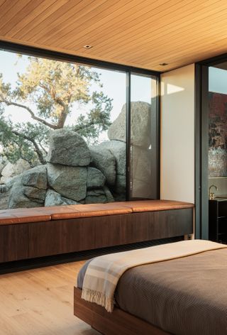 Bedroom looking out at rocks at High Desert Retreat by Aidlin Darling Design