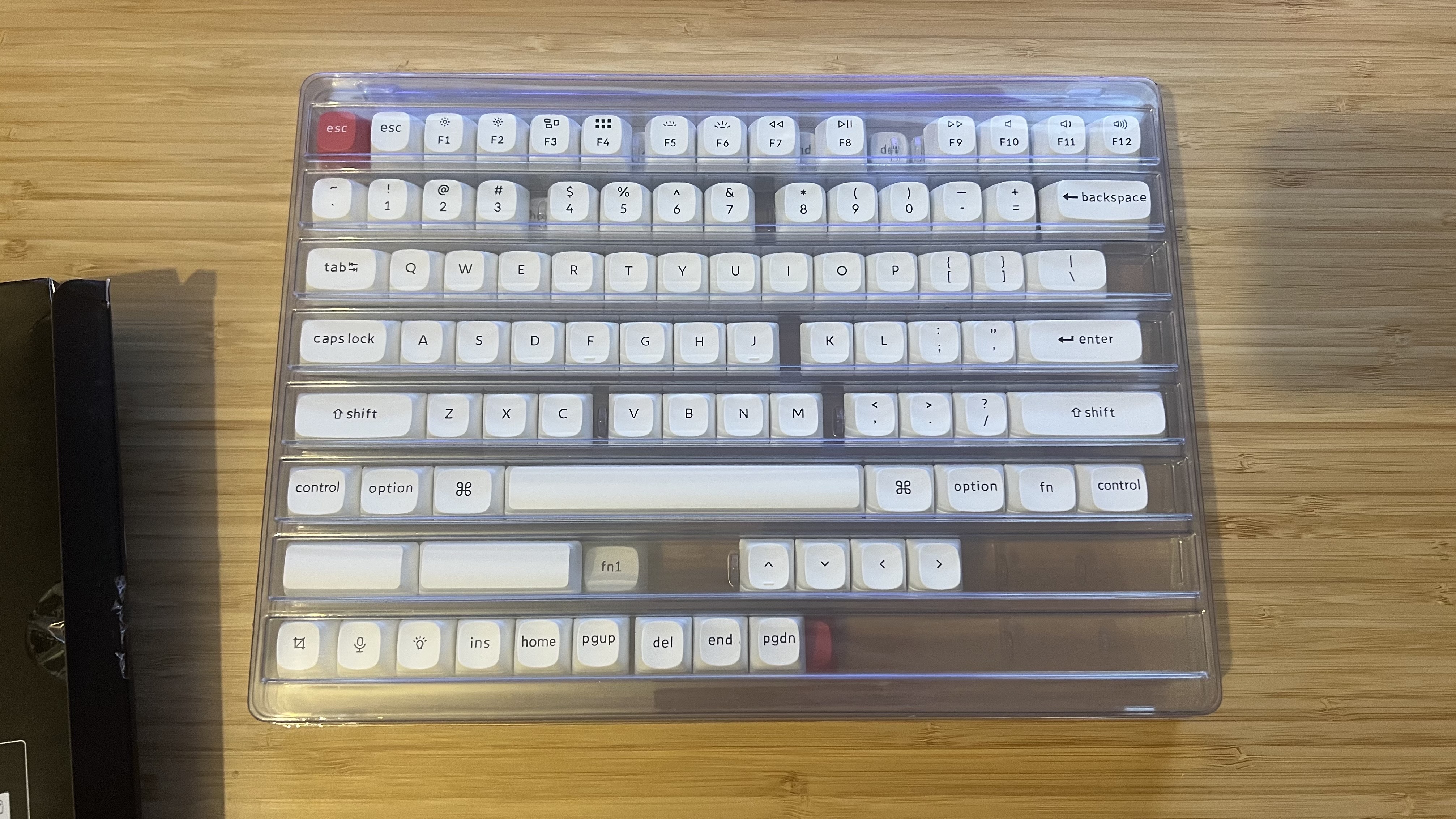 Keychron PBT keycaps in packaging on a wooden desk