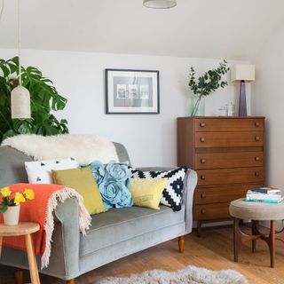 exterior of scandi house bedroom sitting area with sofa cushions and chest of drawers