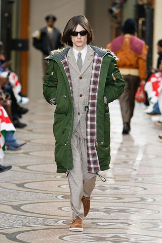 Male model in suit & green parka coat