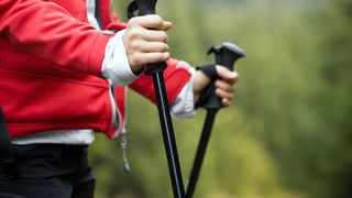 Woman holding hiking poles