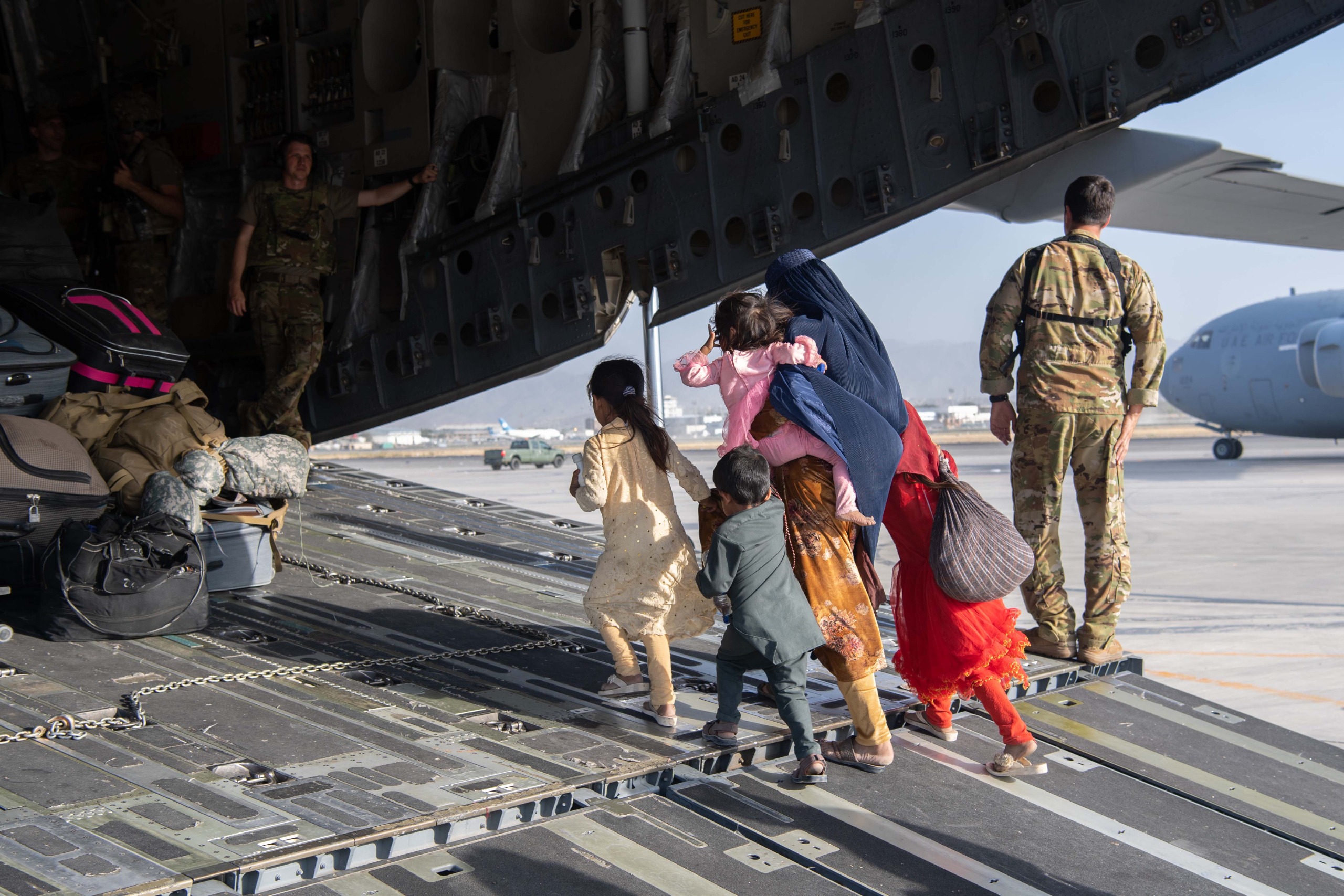 U.S. Air Force load passengers aboard a U.S. Air Force C-17 Globemaster III in support of the Afghanistan evacuation at Hamid Karzai International Airport