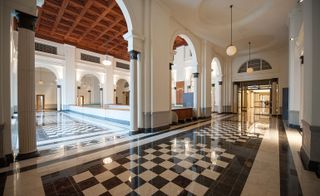 The old courtrooms, light-filled marbled public corridors