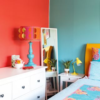 Brightly coloured bedroom with colourful lampshade and bedding