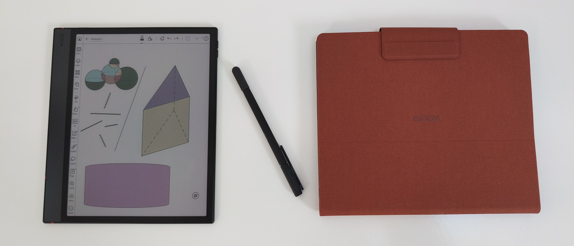 An overview layout featuring the Onyx Boox Note Air 5 C tablet displaying geometric sketches, positioned next to its black stylus and a closed rust-orange folio case.