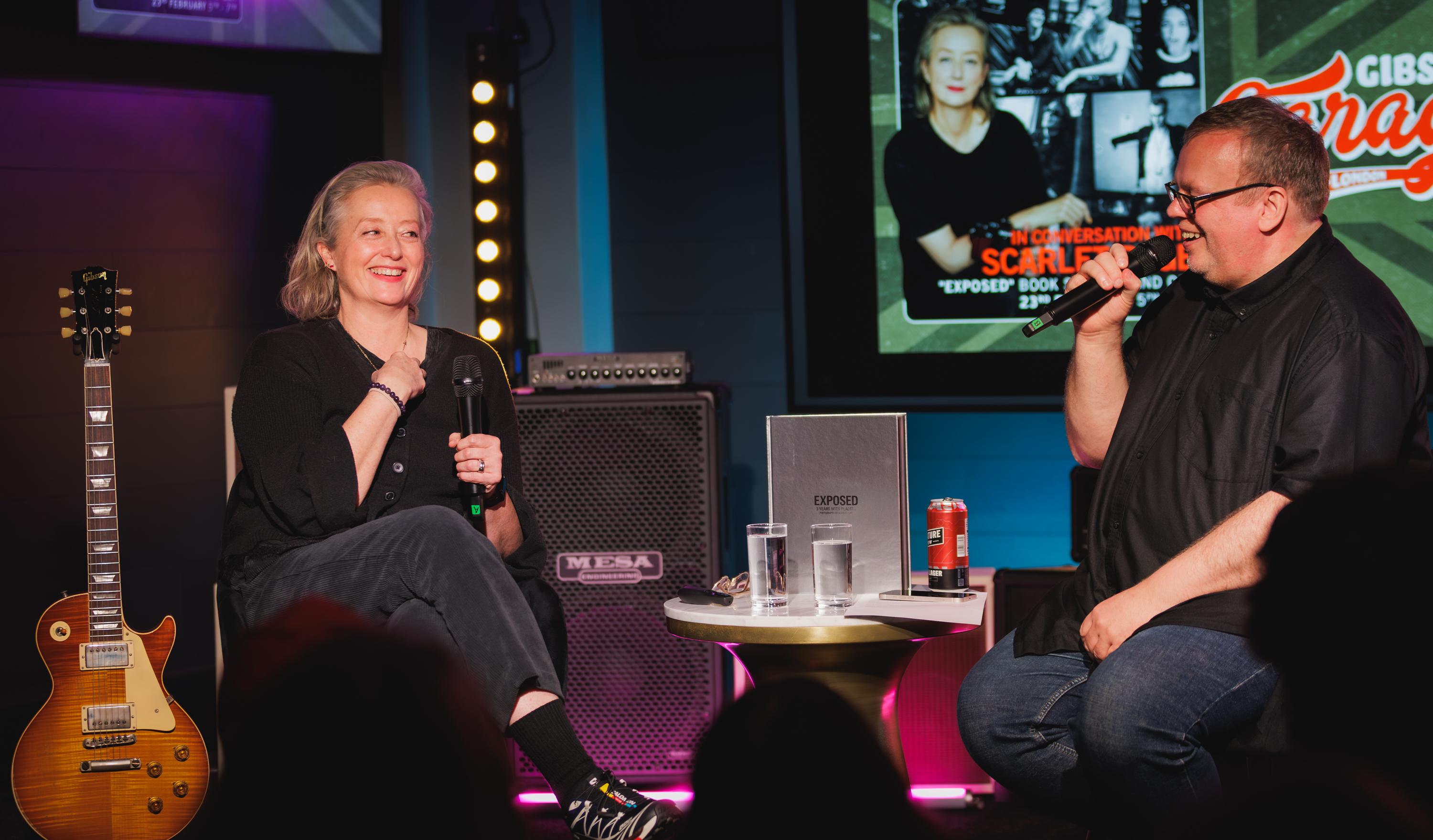 Scarlet Page on stage with Exposed book and Paul Brannigan