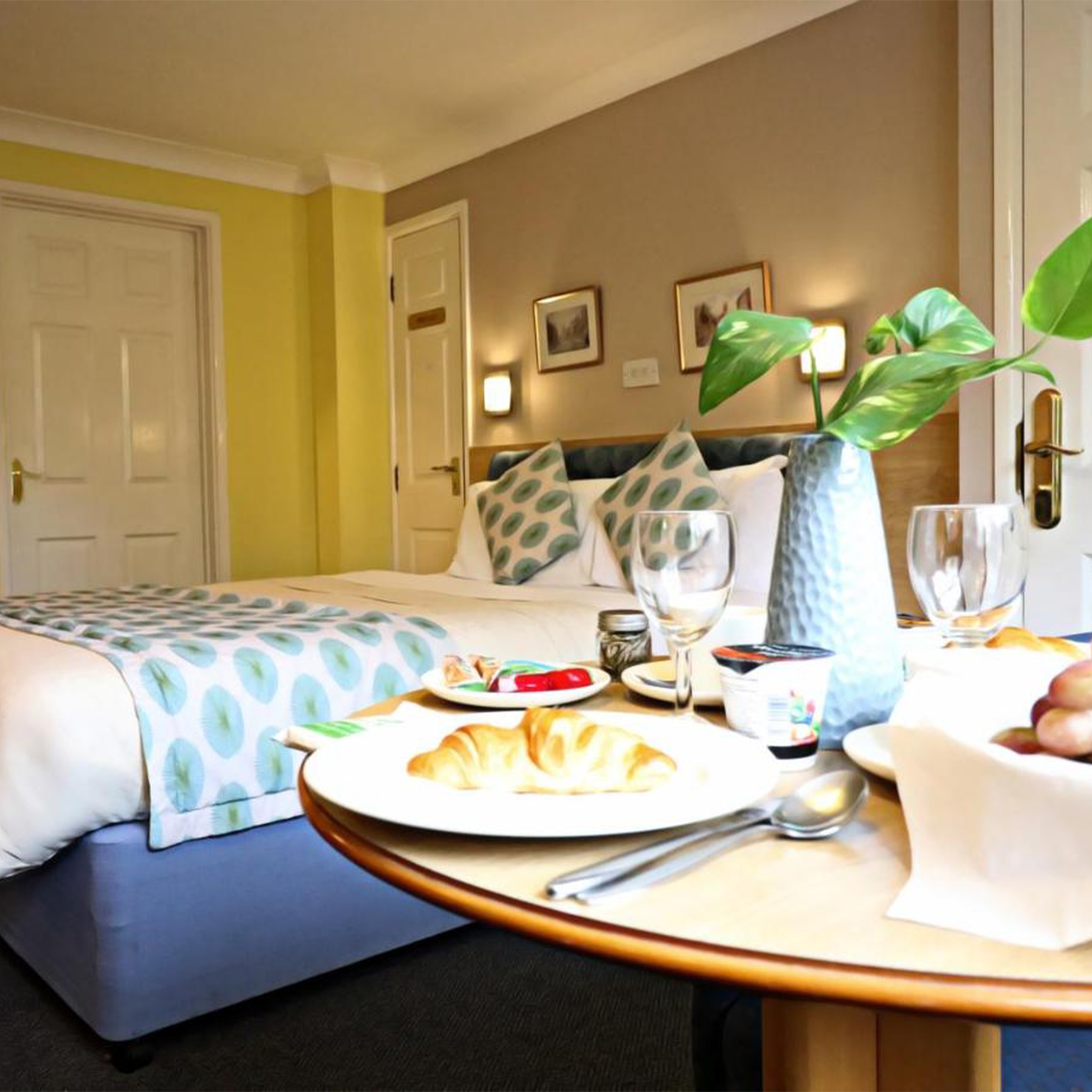 Close up of bed with breakfast in foreground