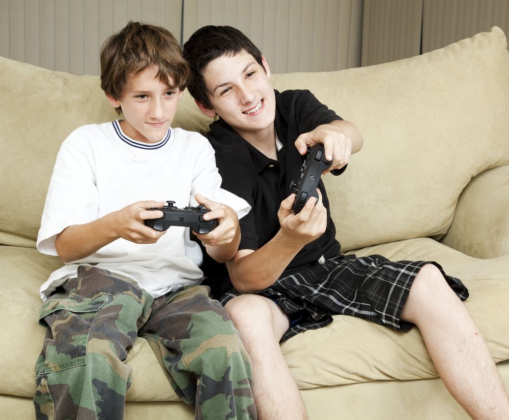 Two teenage boys play a game.