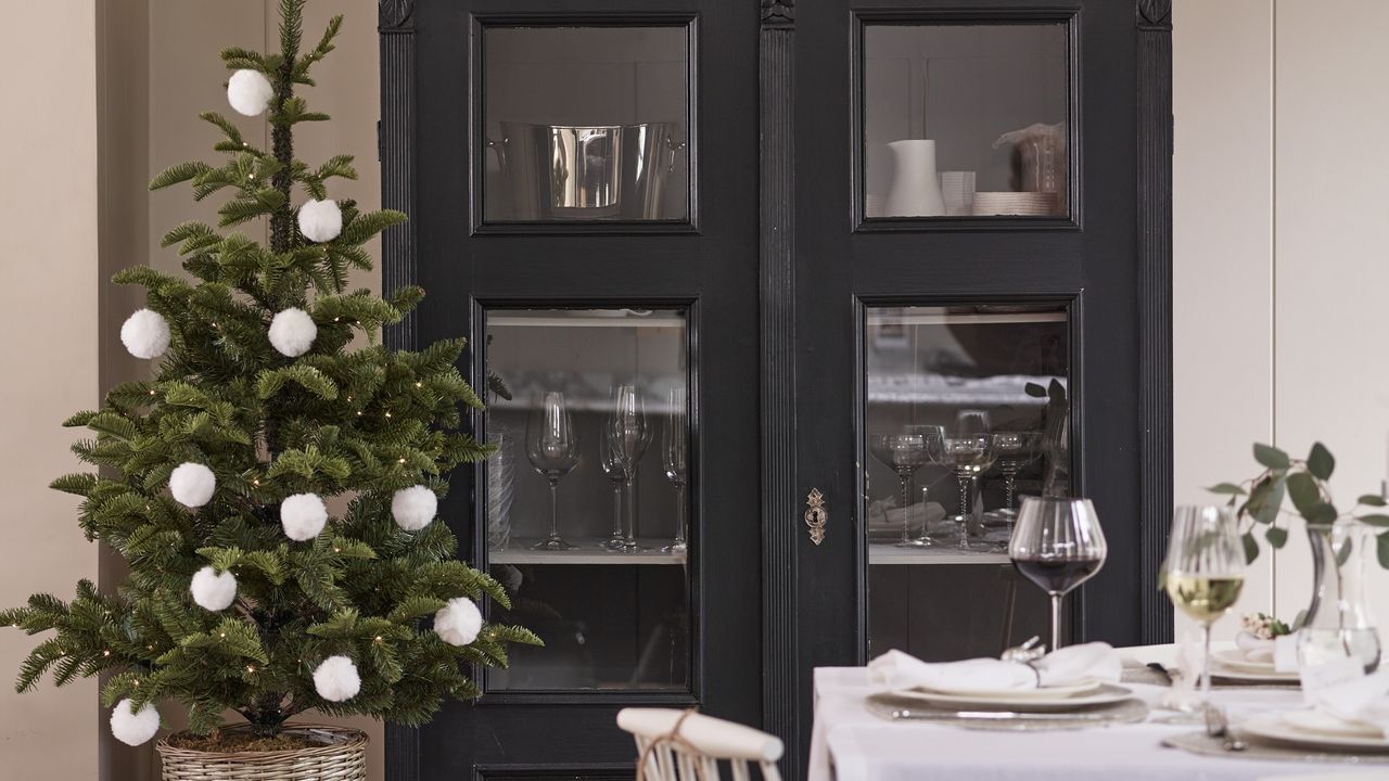 A small Christmas tree in a dining room