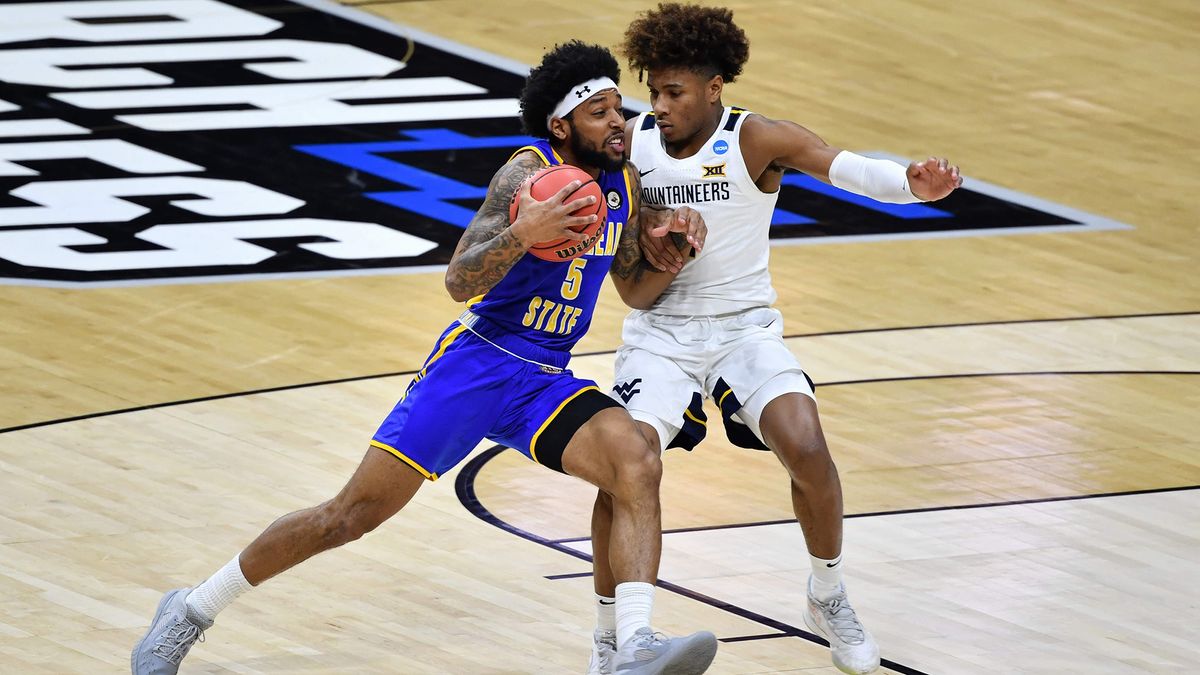 Skyelar Potter #5 of the Morehead State Eagles attempts to drive to the basket as Miles McBride #4 of the West Virginia Mountaineers defends in the second half in the first round of the 2021 NCAA Division I Men&#039;s Basketball Tournament held at Lucas Oil Stadium on March 19, 2021 in Indianapolis, Indiana.